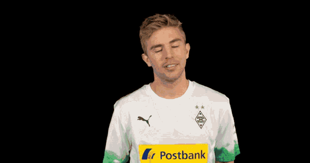 a man wearing a white shirt with a yellow stripe that says postbank