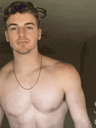a shirtless young man wearing a chain around his neck