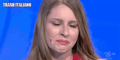 a woman crying in front of a microphone with trash italiano written on the bottom
