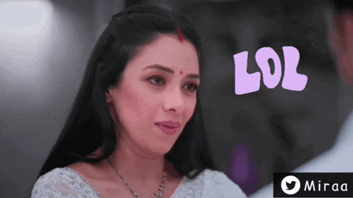 a woman with a red bindi on her forehead looks at the camera with the words lol behind her
