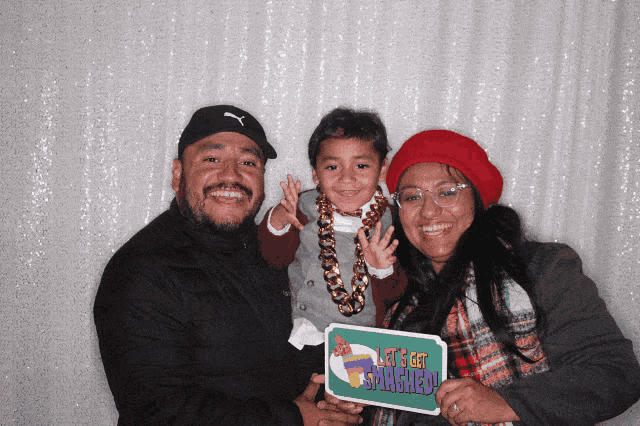 a family holding a sign that says let 's get smashed