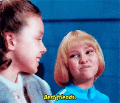 two little girls are talking to each other and one of them says best friends