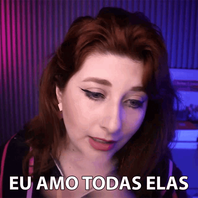 a woman with red hair says eu amo todas elas in a video