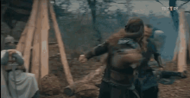 a group of soldiers are fighting each other in a forest .