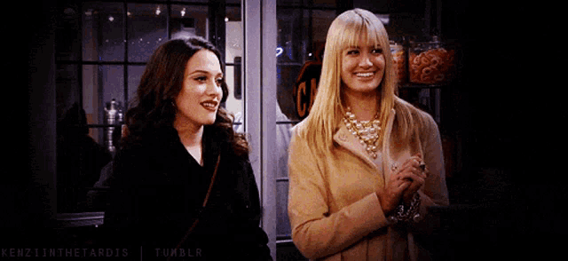 two women standing next to each other in front of a sign that says can