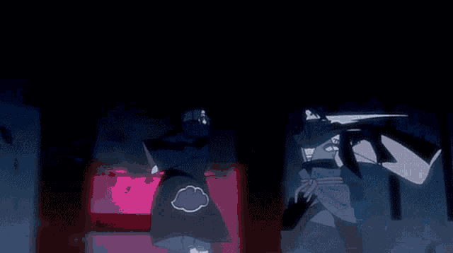 a couple of people standing next to each other in a dark room with fireworks going off in the background .