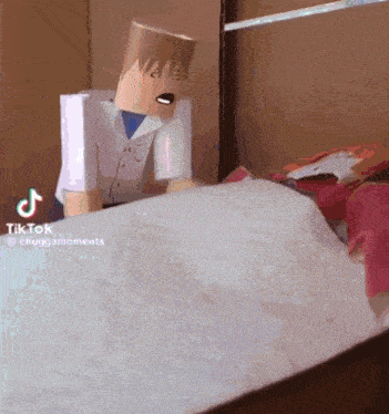 a person with a paper bag on their head is laying on a bed