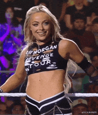 a woman in a wrestling ring wearing a shirt that says liv morgan revenge tour