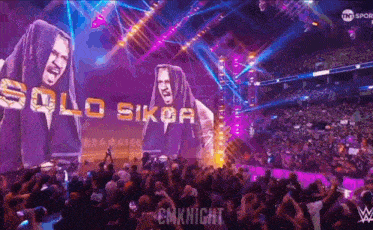 a crowd of people watching a wrestling match with the words solo sikora on the screen