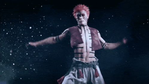 a man with red hair is jumping in the air in a dark room .