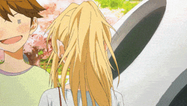 a girl with blonde hair stands next to a boy