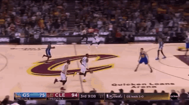 a basketball game is being played on a court with a large c on it