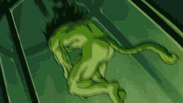 a naked green monster with a long tail is in a glass container