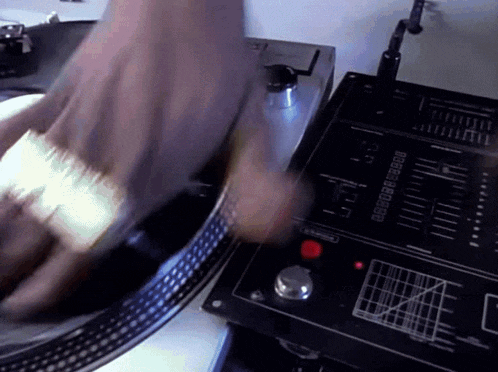 a person is playing a record on a turntable with a red button that says ' pause ' on it