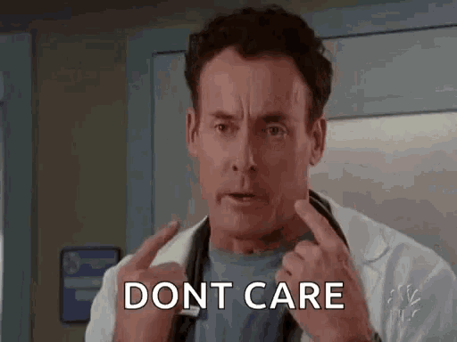 a man in a white lab coat is giving the middle finger and saying `` dont care '' .