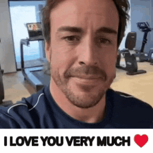 a man is taking a selfie in a gym with the words `` i love you very much '' .