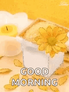 a good morning greeting card with a yellow flower and a candle