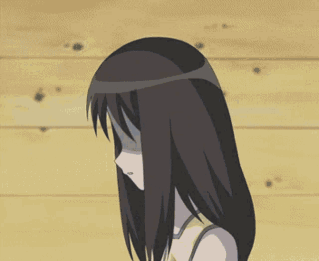 a girl with long brown hair is covering her face