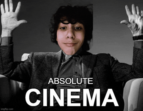 a man in a suit is sitting in a chair with his hands up and the words absolute cinema below him