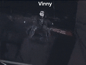 a person standing on a stage with the name vinny written on the bottom