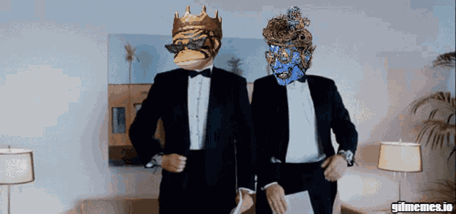 two men in tuxedos are standing next to each other with gifmemes.io in the corner