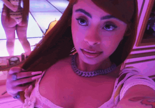 a woman taking a selfie with a purple background