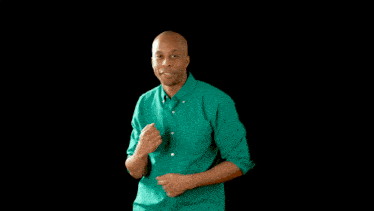a man in a green shirt is standing next to a woman in a yellow shirt