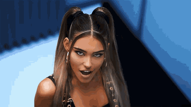 a close up of a woman with two ponytails