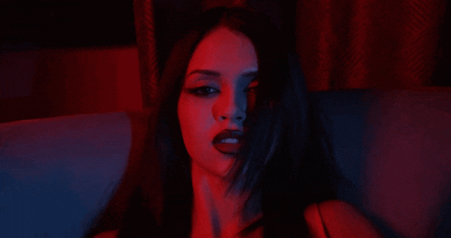 a woman with a red light behind her face
