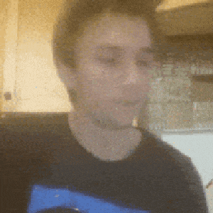 a man wearing a black shirt with a blue stripe on the front