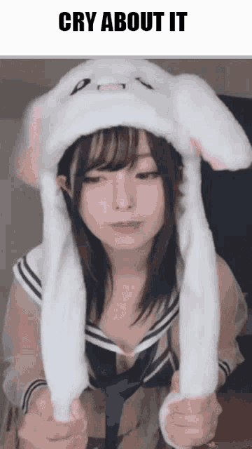 a girl wearing a white bunny hat with the words cry about it written above her