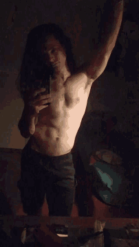 a man without a shirt is laying on his back