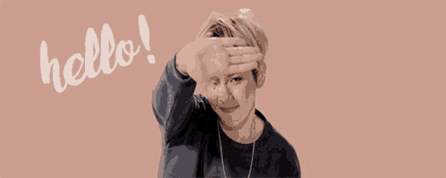 a man is covering his face with his hand and says hello