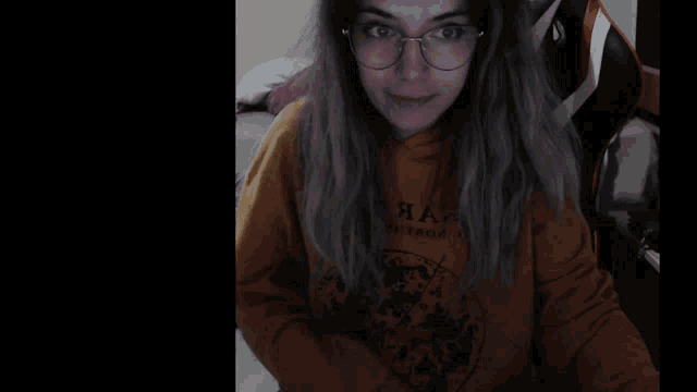 a woman wearing glasses and a yellow shirt that says ' i love you ' on the front