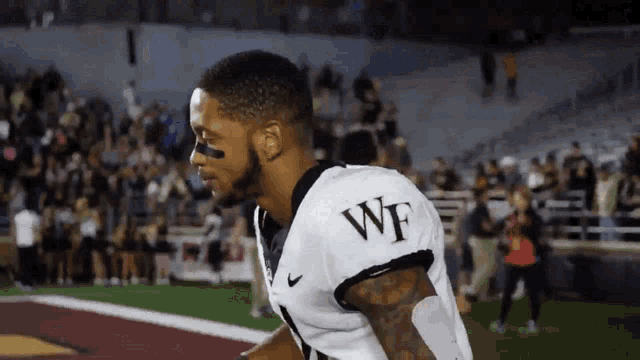 a football player with wf on the back of his shirt