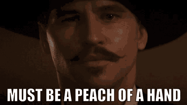 a man with a mustache and a hat has the words must be a peach of a hand above him