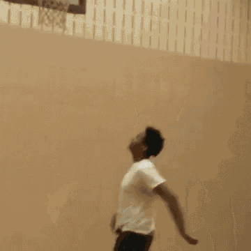 a man in a white t-shirt is making a funny face .