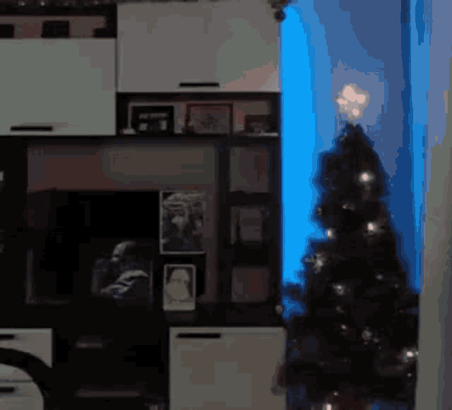 a christmas tree is lit up in a living room