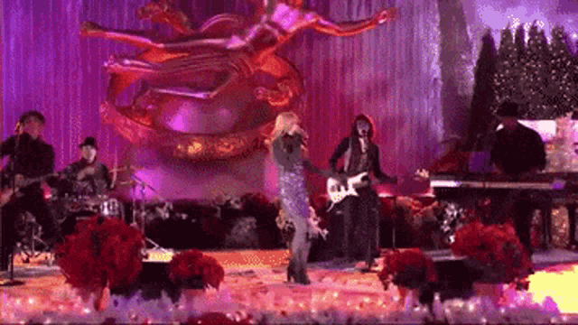 a group of people are playing instruments on a stage