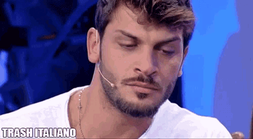 a man with a beard is wearing a white t-shirt and a microphone with the words trash italiano on the bottom