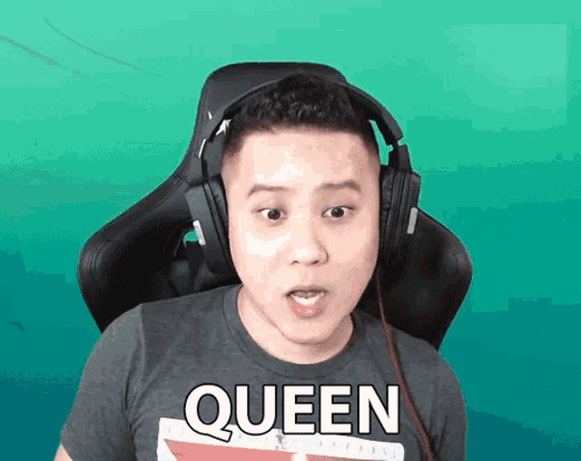 a man wearing headphones and a shirt that says queen on it