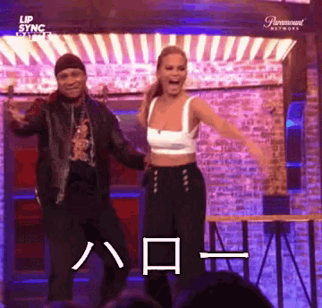 a man and a woman are dancing in front of a paramount network advertisement