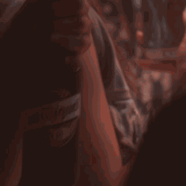 a close up of a person holding a bottle of san miguel