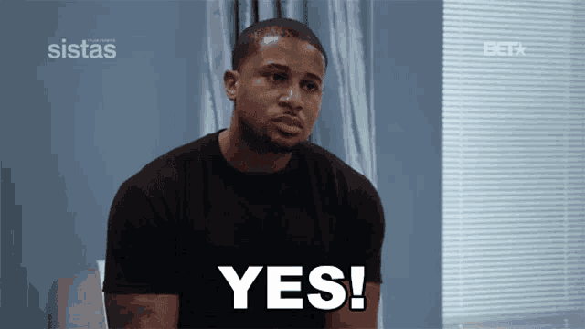 a man in a black shirt says yes in front of a bet logo