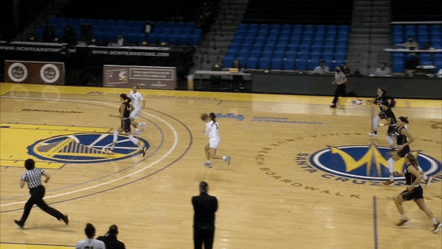 a basketball game is being played on a court that says santa cruz