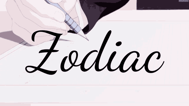 a person is writing the word zodiac on a piece of paper with a pen