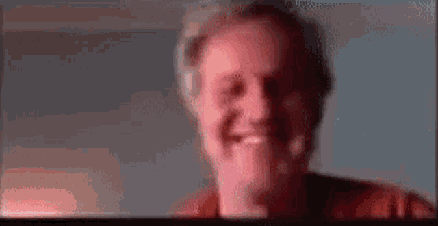 a close up of a man 's face with a blurred background .