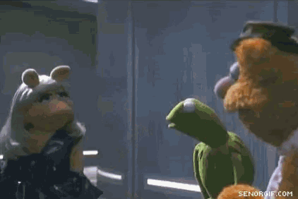 a group of stuffed animals are standing next to each other .