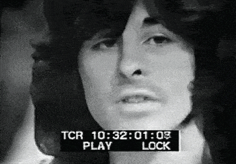 a black and white photo of a man 's face with a play and lock button on the bottom of the screen .