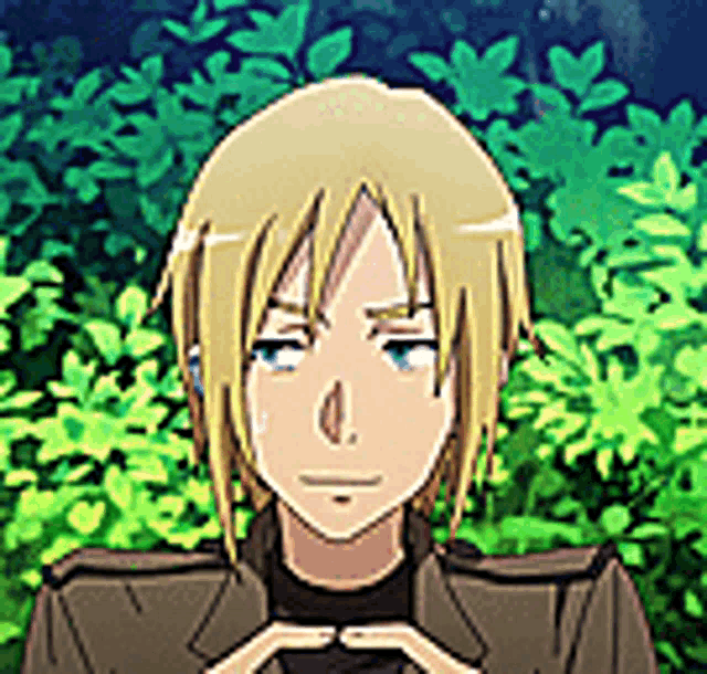 a cartoon character with blonde hair and blue eyes is standing in front of a green bush .